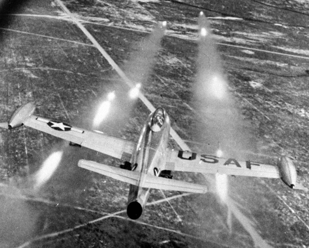 An F-84E unleashes a salvo of rockets on a ground target (US Air Force)